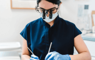 dentist with medical cabinetry behind her